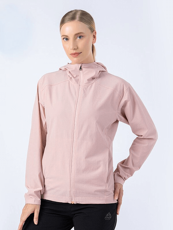 Woman wearing pink waterproof sports jacket with hood, SF0897, ideal for running and outdoor activities.